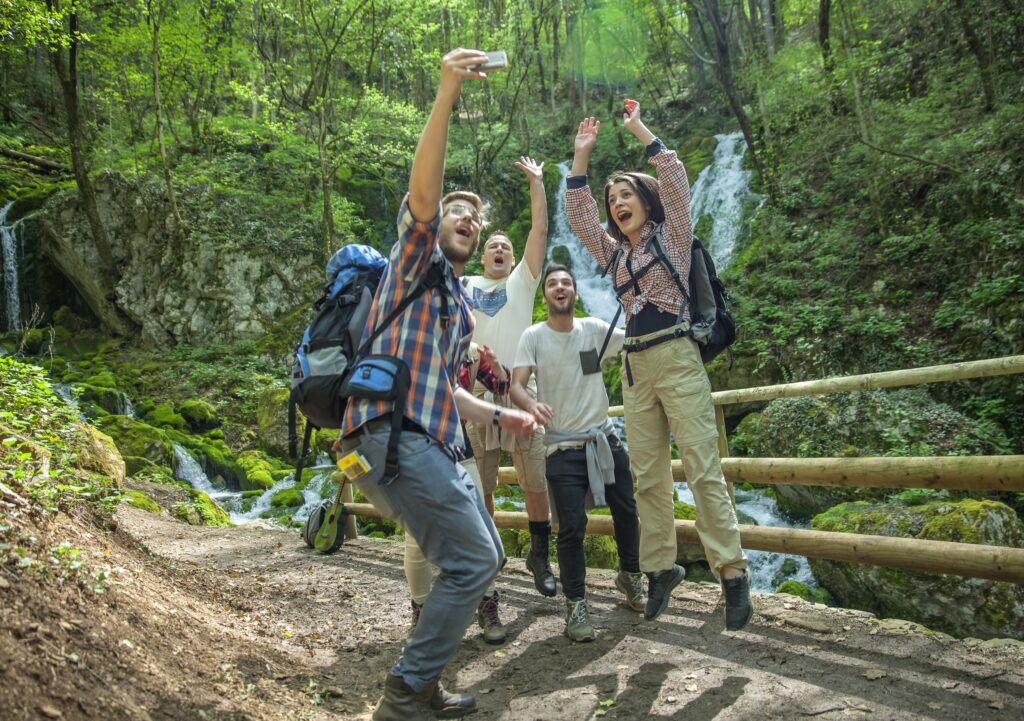 group-friends-having-fun-taking-selfies-nature