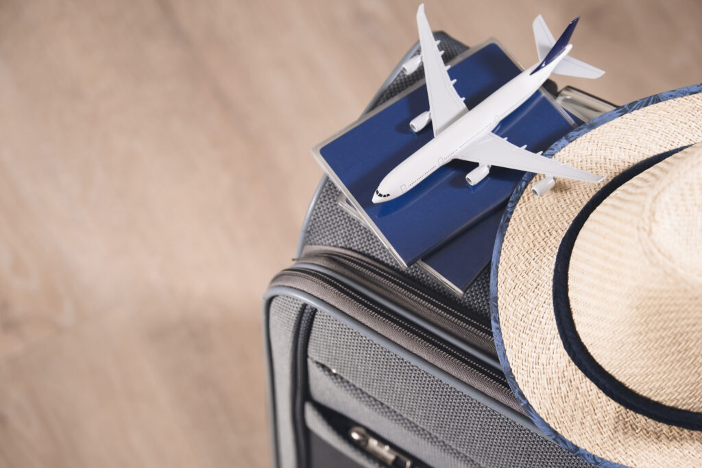 lifestyle-traveling-concept-passports-hat-model-airplane-gray-suitcase
