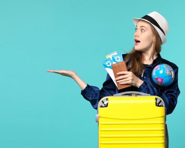 front-view-young-woman-holding-tickets-globe-light-blue-background-plane-sea-vacation-journey-voyage