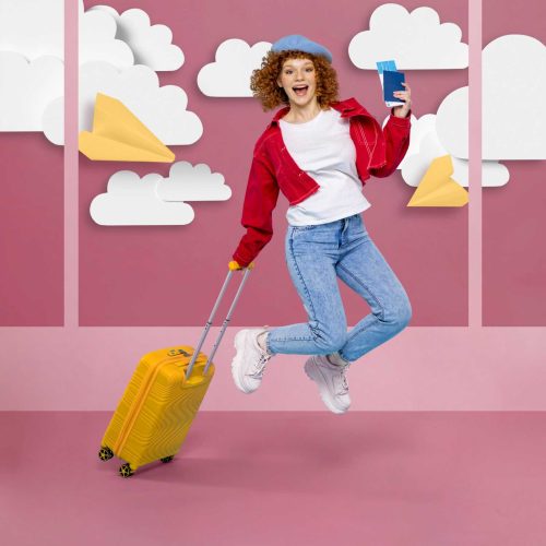 side-view-woman-jumping-while-holding-suitcase-airplane-ticket